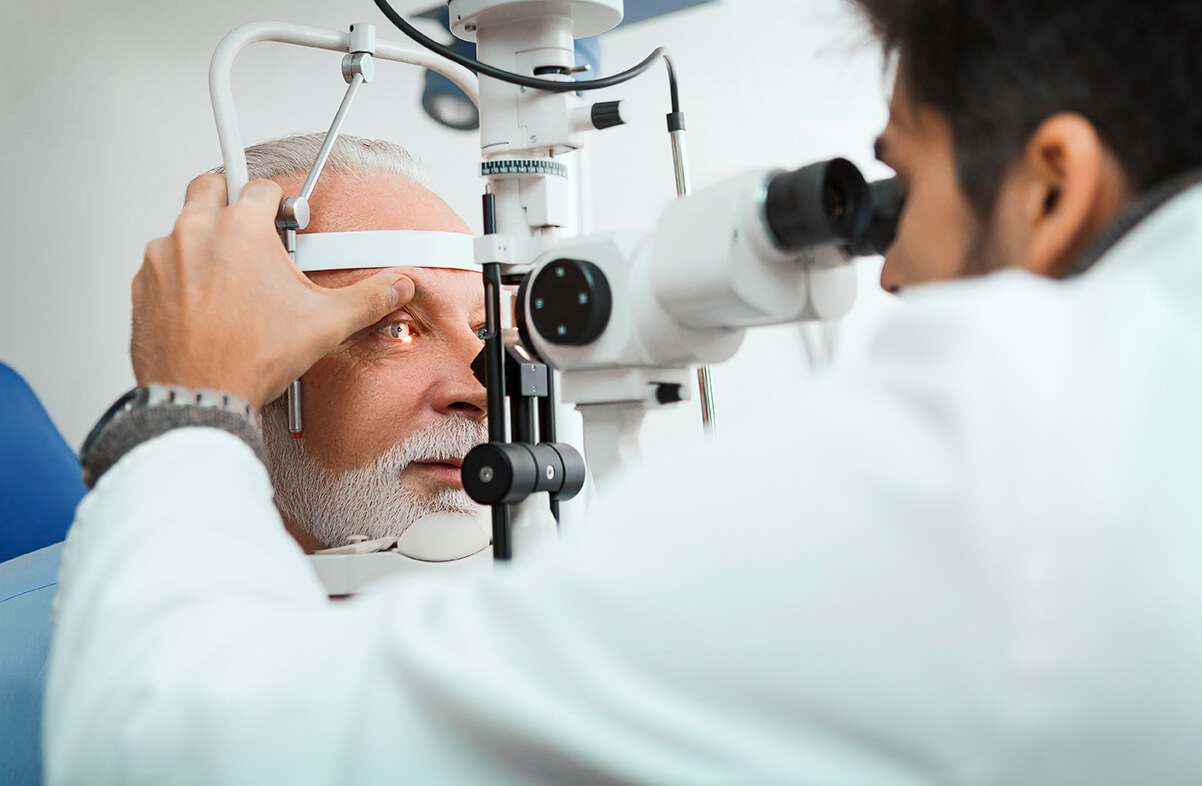 Optometrist checking senior man with optometry machine McGuffey